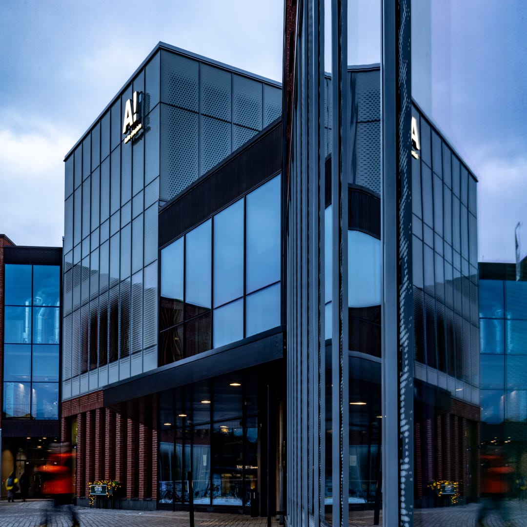 architecture,building,office building,convention center,city,person,urban,shoe,car dealership,vehicle