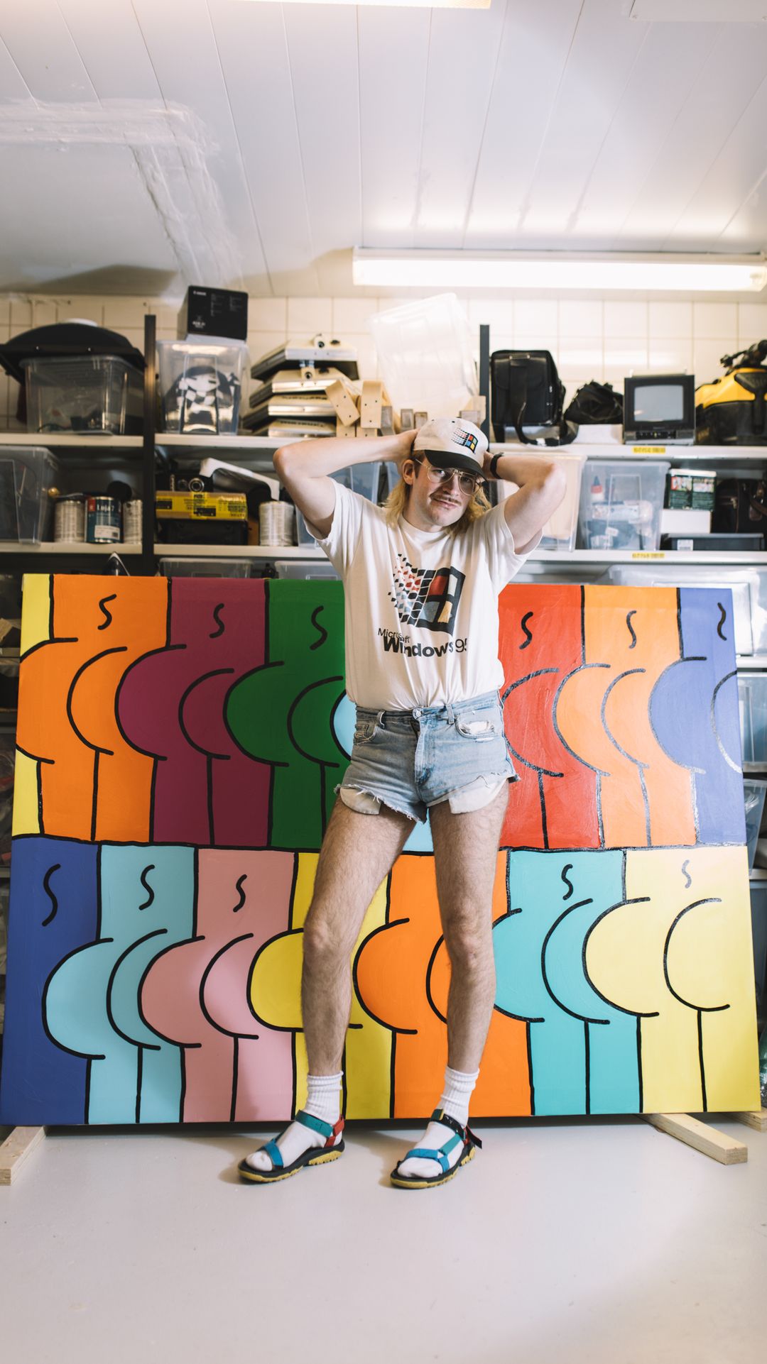 clothing,person,shorts,shelf,screen,hat,monitor,furniture,lcd screen,art