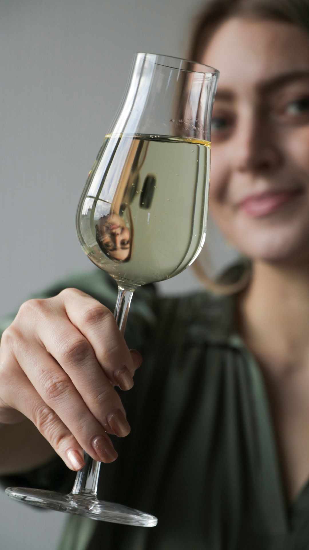glass,goblet,person,human,finger,alcohol,beverage,wine glass,wine,wristwatch