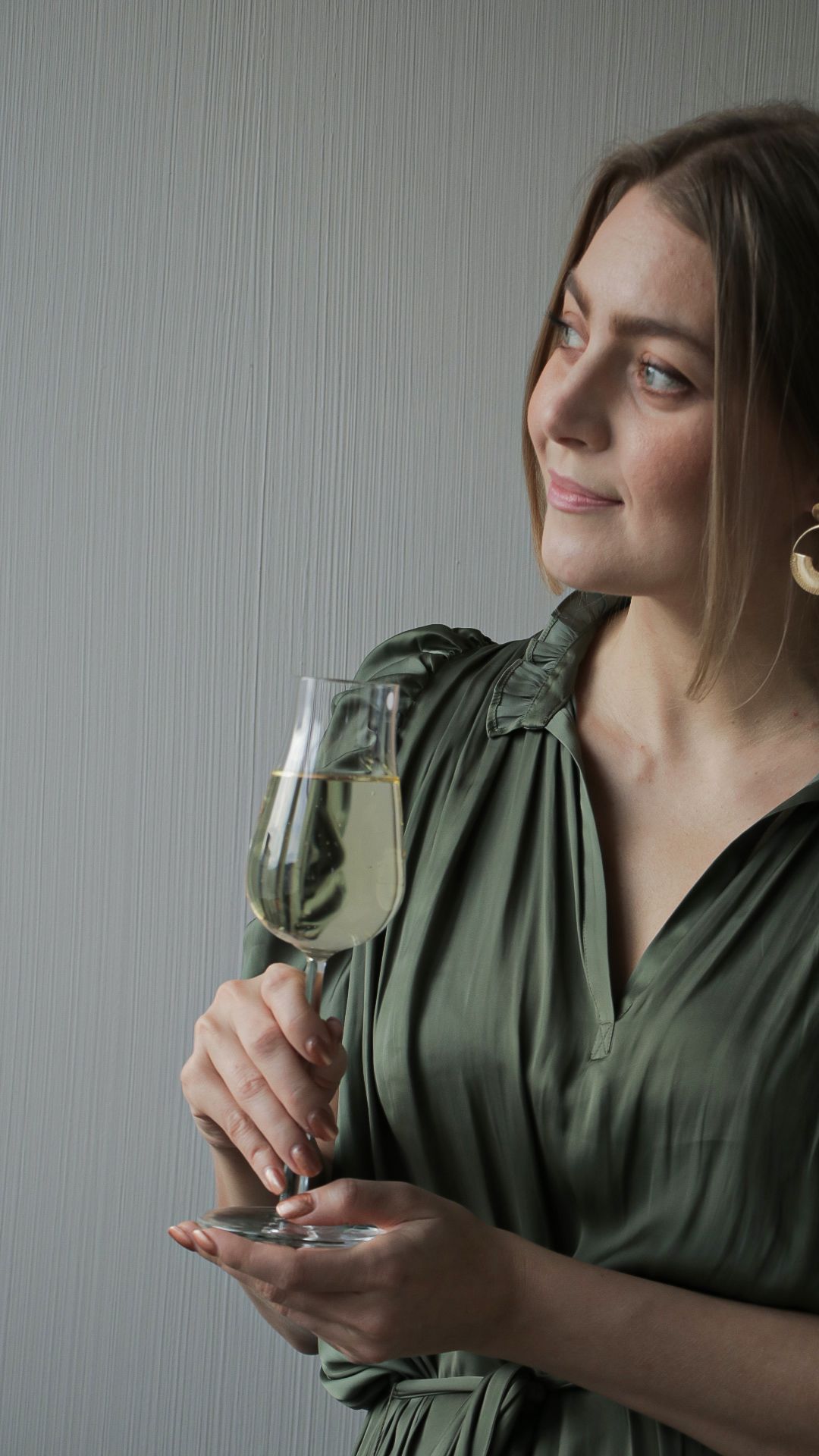 person,glass,clothing,goblet,evening dress,fashion,home decor,sleeve,finger,head